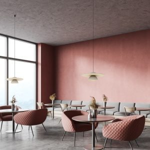 Corner of panoramic restaurant with pink walls, concrete floor, round tables with comfortable pink armchairs, gray sofa and wooden chairs. Window with blurry mountain view. 3d rendering